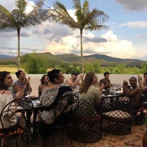 retreat group having dinner on veranda enjoying view of rice fields in Chiang Mai